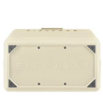 The underside of the cream FIELDBAR cooler is shown, featuring an embossed FIELDBAR logo centered on the base. Reinforced metal corner plates and exposed screws add durability while maintaining the cooler's premium design.