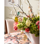 Vase with floral and branches with hanging glass easter eggs