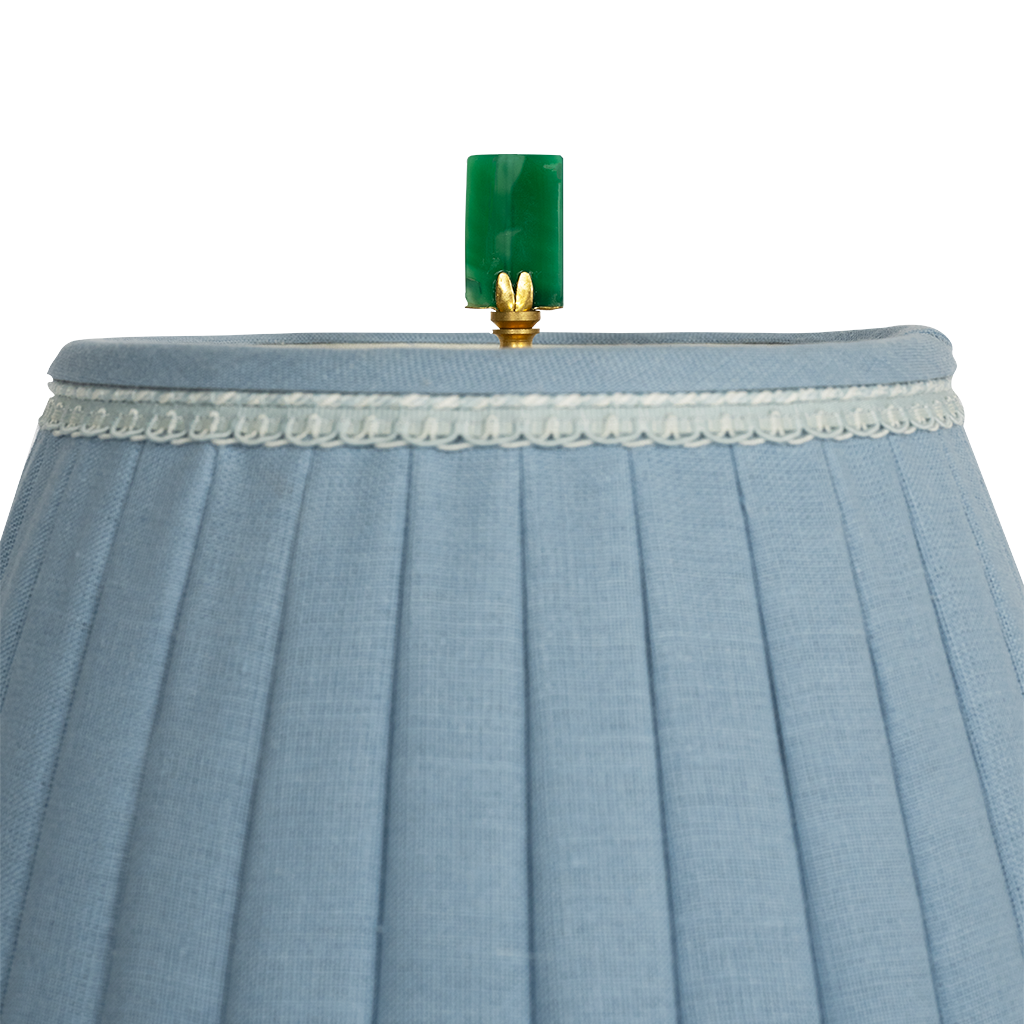 green pendant on top of lamp shade