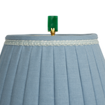 green pendant on top of lamp shade