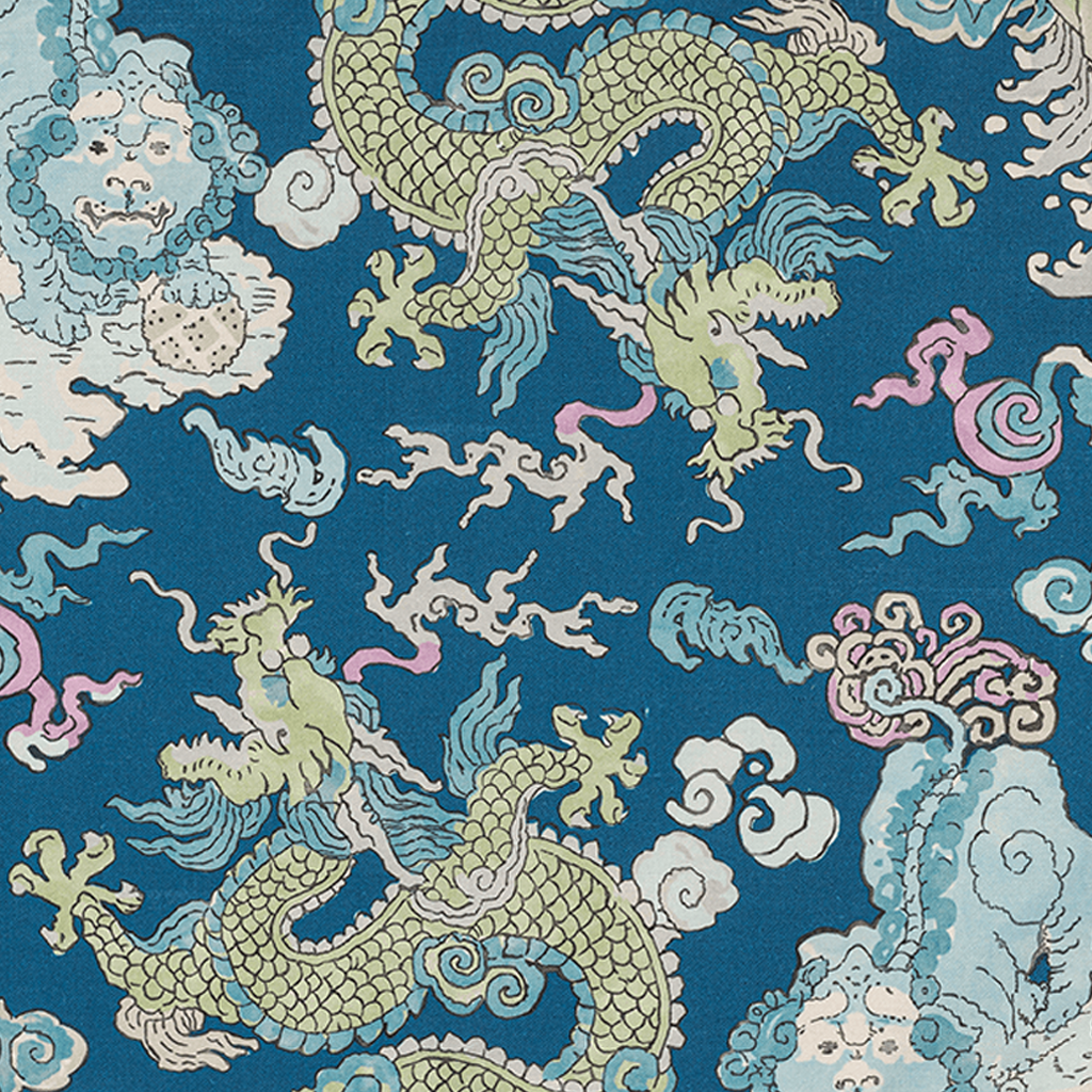 Blue tablecloth with intricate pastel dragons and swirling clouds in green, pink, and cream tones.