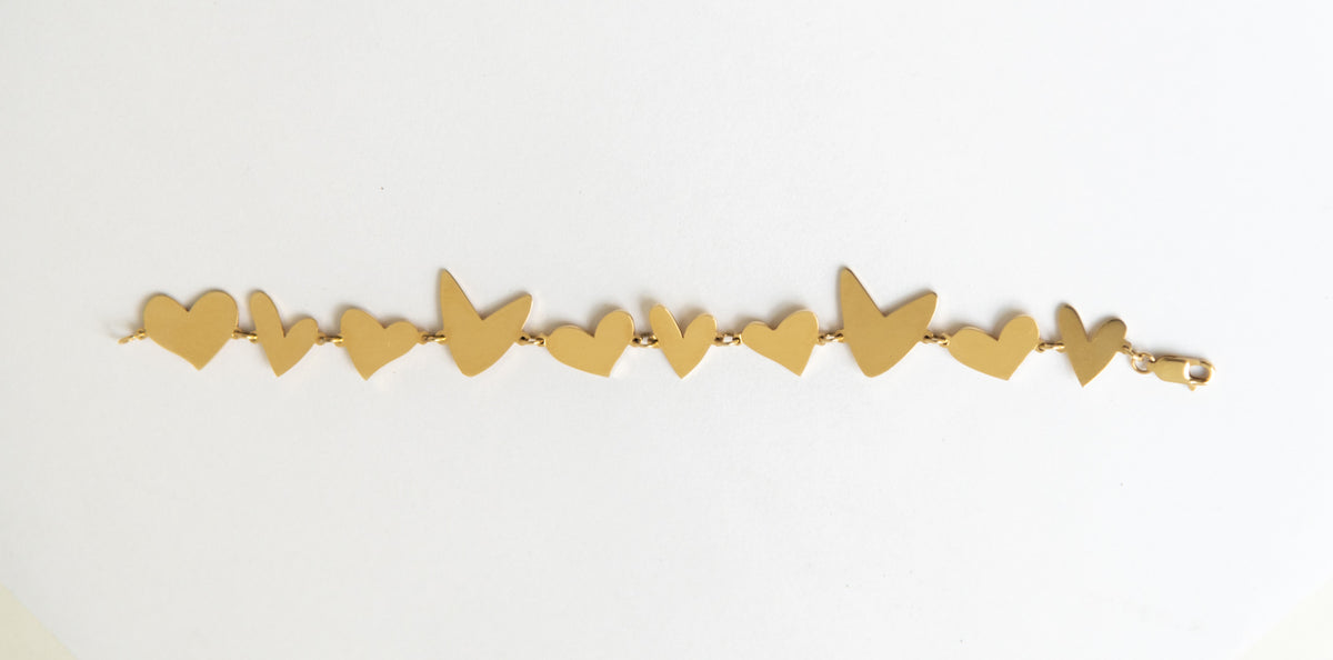 An All My Hearts bracelet laid flat on a white background