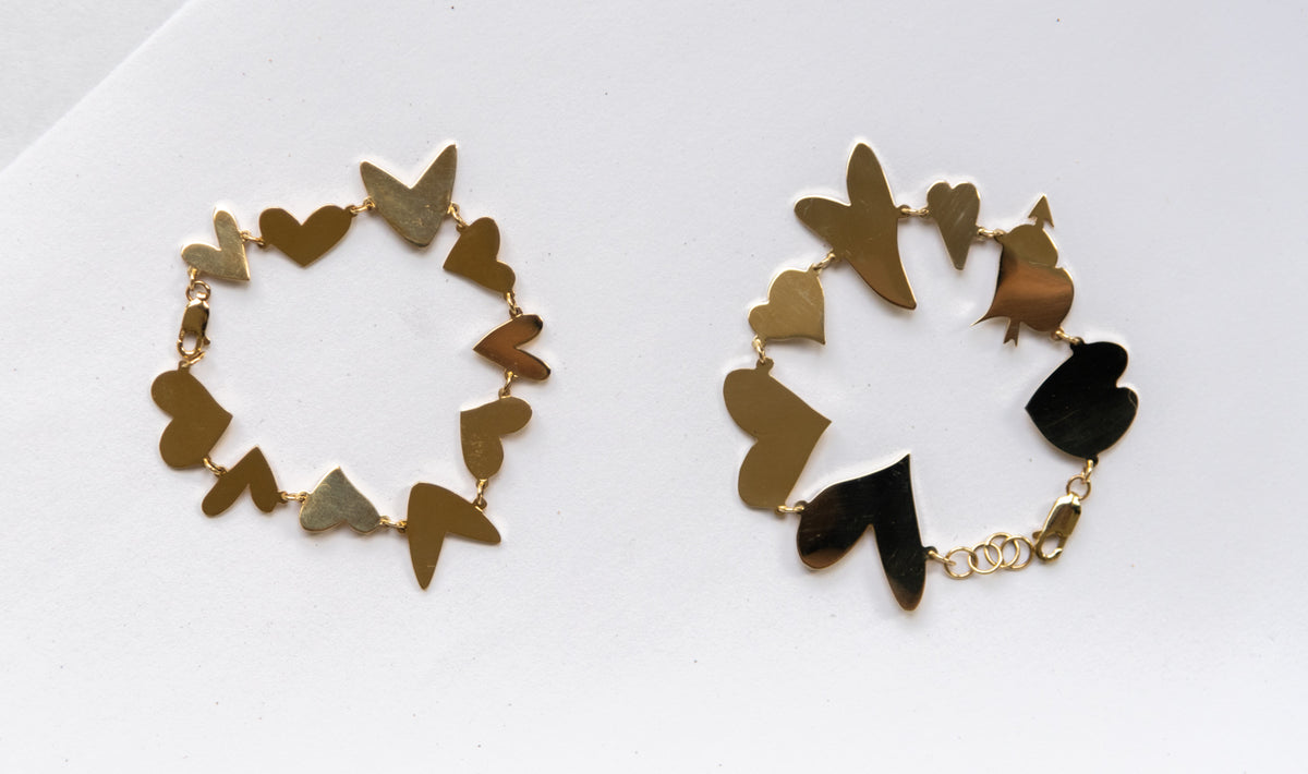 Two different All My Hearts bracelets laid flat next to one another each arranged in a circle