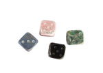 An aerial view of andean stone dice, set of four. Each dice is a different color: pink, blue, green, black