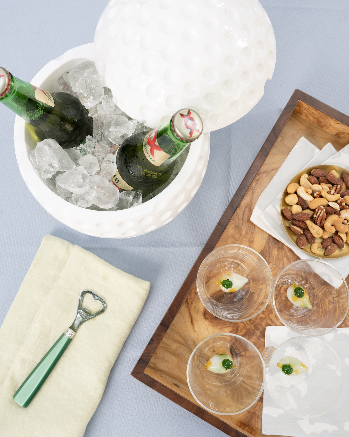 white golf ball ice bucket next to a burl wood tray