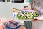 model holding platter with bamboo salad serving set