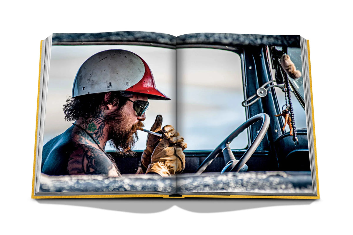 photo of the Race of the Gentleman book, open showing photo of man smoking a cigarette in a car