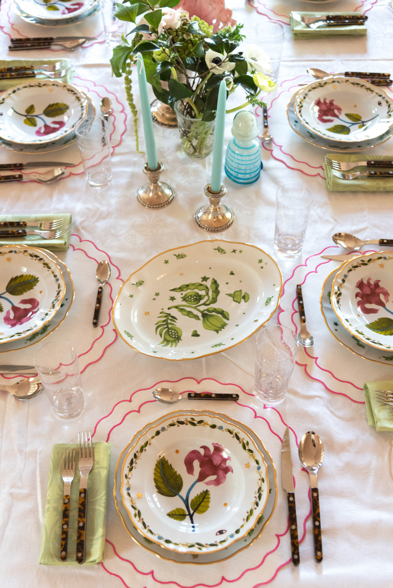 Full view of tablescape display with Italiano Bloom Deep Plate in Pink