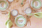 Birds eye view of Mottahedeh Lace Butterfly Accent Plate in green apple with dinner plate, flatware, napkin on top of tablecloth