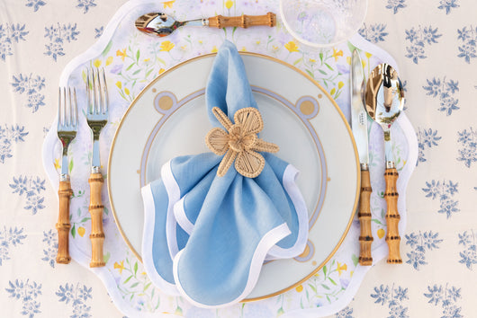 Vintage Lavender Dinner Plate styled with bamboo flatware, blue scalloped napkin, and orchid napkin ring