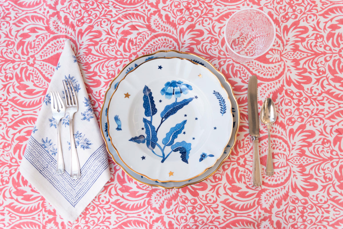 Jasmine Blue Napkin displayed with flatware, accent plate, dinner plate and glassware on top of tablecloth