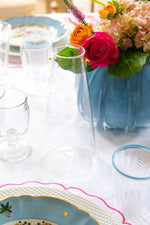 Three Tiered White Embellishment Carafe styled on table next to floral arrangement