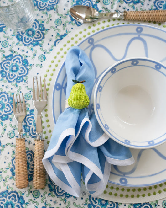 Woven Pear Napkin Ring on blue napkin on table