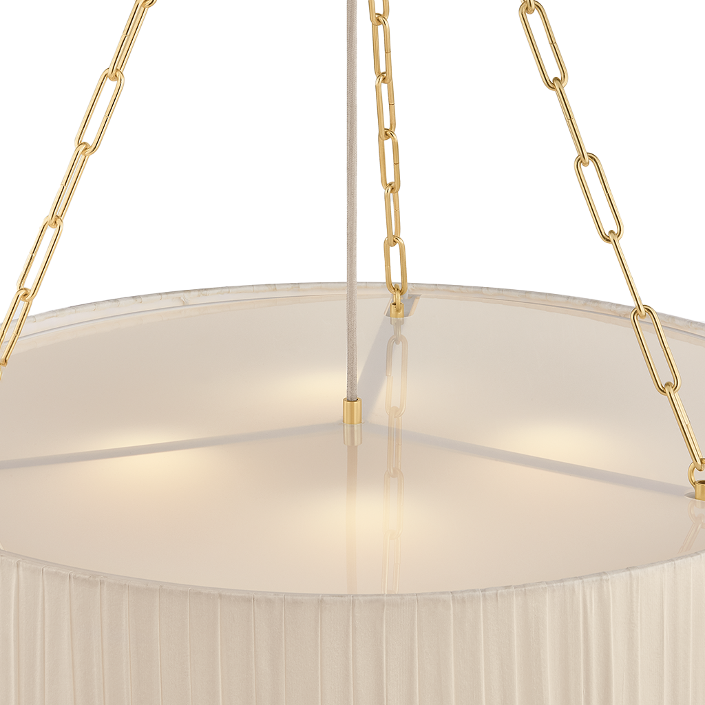 Close-up of a hanging chandelier with a large circular white fabric shade, gold chain suspension, and a central vertical rod against a white background.