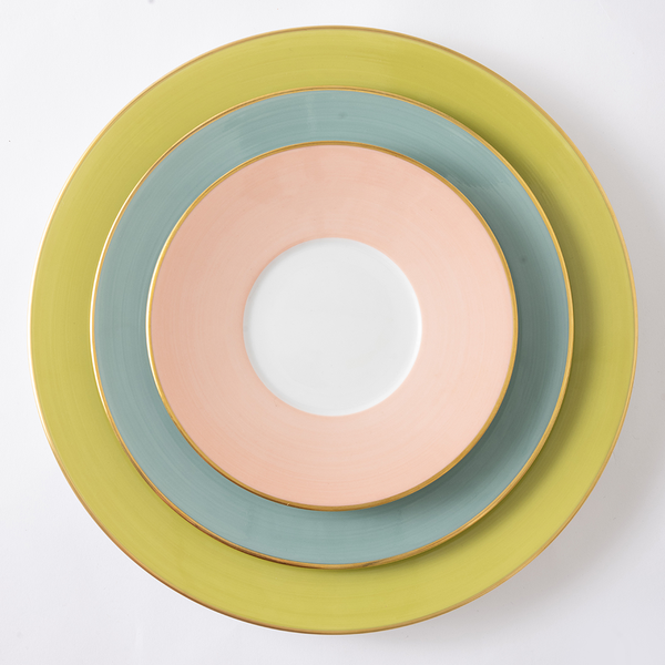 Stack of colorful ceramic plates on a white background