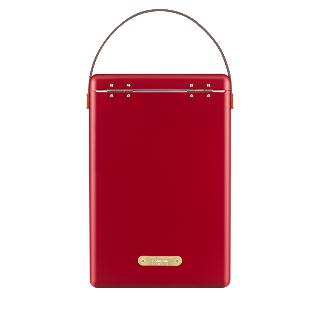 back of A red metal Fieldbar wine cooler with a brown faux-leather handle on a white background.