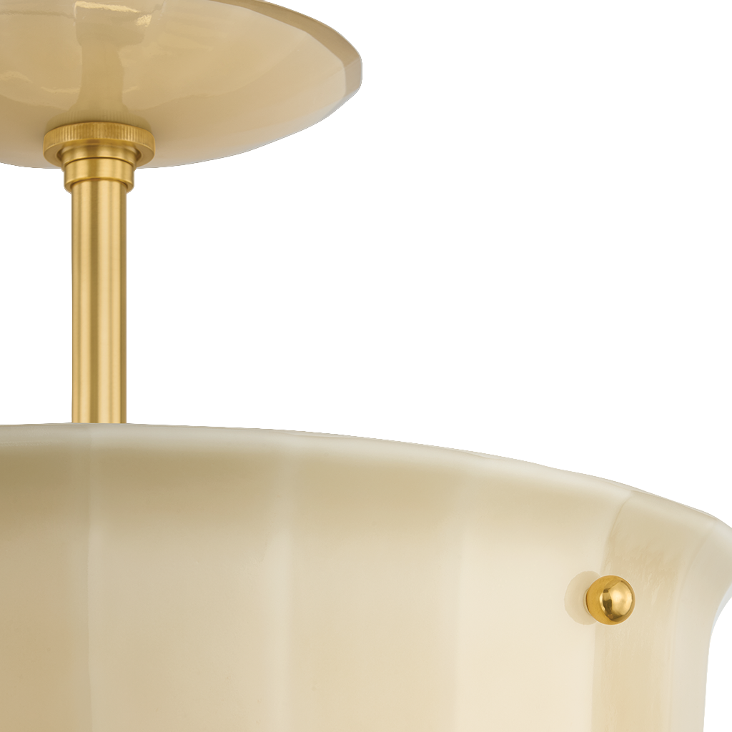 Close-up of a semi-flush mount ceiling light fixture with a warm cream-colored glass shade and polished gold/brass metal hardware against a white background.
