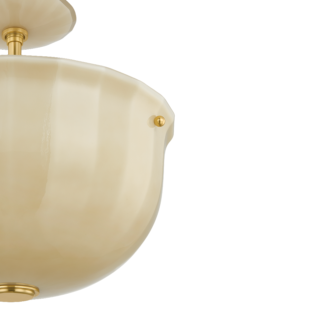Close-up of a cream-colored semi-flush mount ceiling light fixture with a fluted glass shade and gold-toned metal hardware, shown against a plain white background.