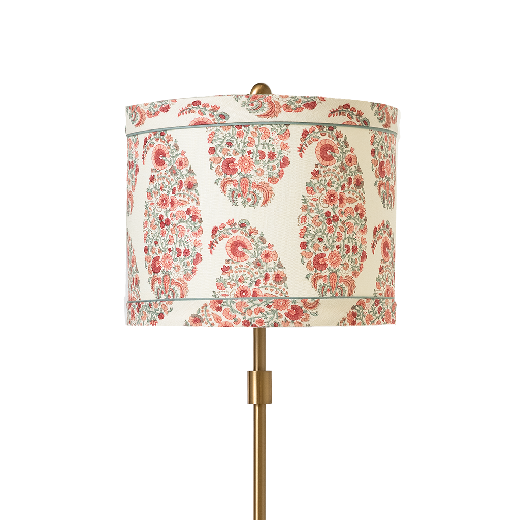 Lamp with a floral patterned shade on a white background