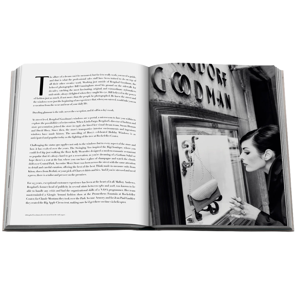 An open hardcover book laid flat on a white background, showing printed text on the left page and a black-and-white photograph on the right with a woman standing in front of a window. The cover edge is visible at the top.