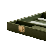 Close-up of an olive green game board or tray with a gold clasp, showing a glass top edge and white game pieces inside on a white background.