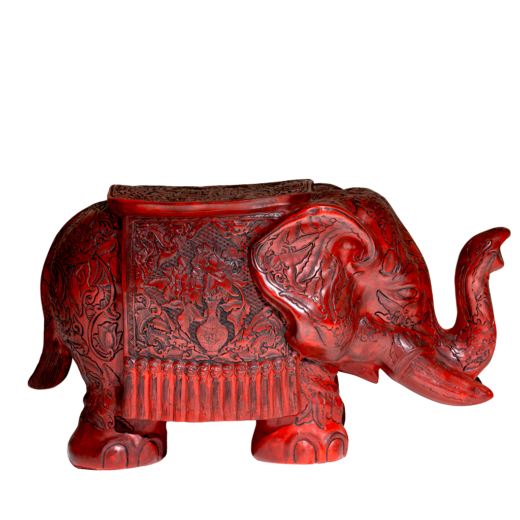 Decorative red elephant figurine with intricate carvings on a white background
