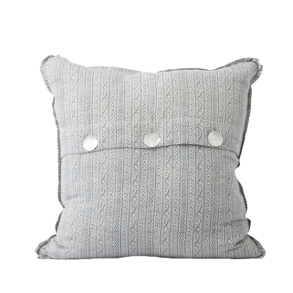 The back of the square decorative throw pillow features the same white fabric with a delicate blue vertical stripe and floral pattern. An envelope-style closure secured with three white buttons adds a functional and classic finishing detail.