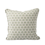 A square decorative throw pillow features an ivory fabric with a repeating botanical motif in muted sage green and golden tan. The subtle block-printed style and soft color palette create a timeless, elegant look.