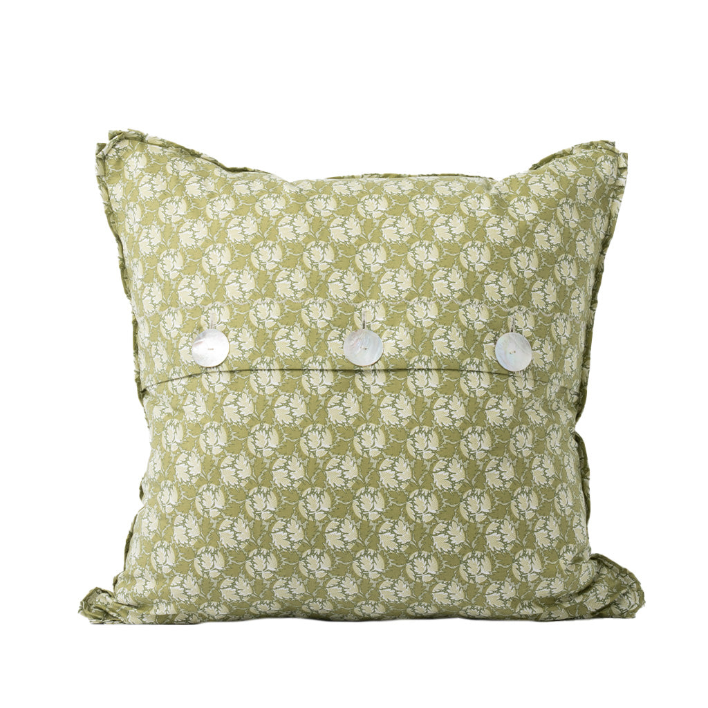 The back of the square decorative throw pillow features the same soft sage green and ivory floral pattern as the front. An envelope-style closure secured with three white buttons adds a classic, functional finishing detail.