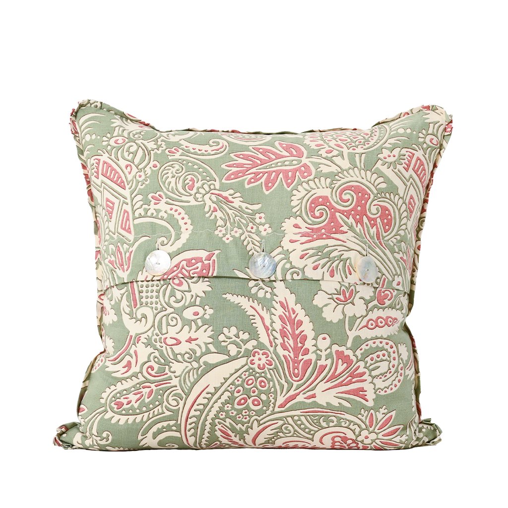 Decorative pillow with pink and green paisley pattern on a white background