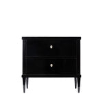 Front view of an antique ebonized two-drawer chest with a sleek black finish, clean lines, and tapered legs. Ivory-colored keyhole escutcheons provide a subtle contrast, emphasizing the piece's refined, minimalist design.