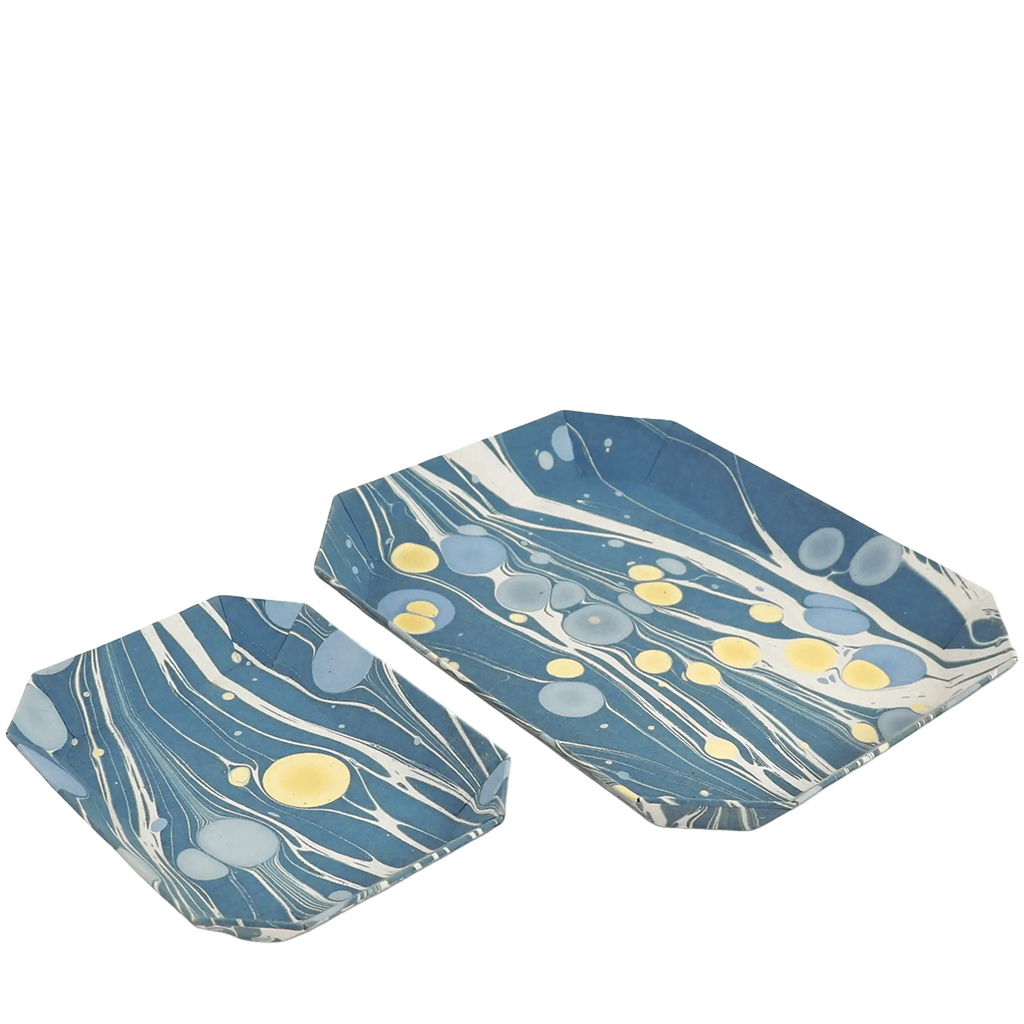 Two blue marbled trays with yellow accents on a white background