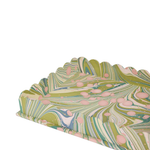 Marbled paper with green, pink, and blue patterns on a white background