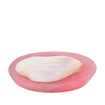 Pink dish with pearl insert on a white background