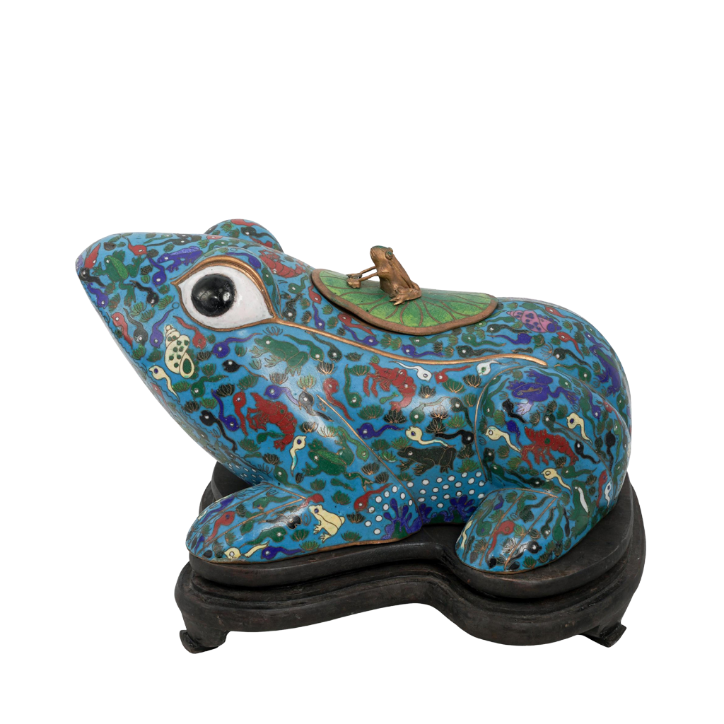 Decorative frog sculpture with intricate patterns on a white background