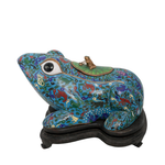 Decorative frog sculpture with intricate patterns on a white background