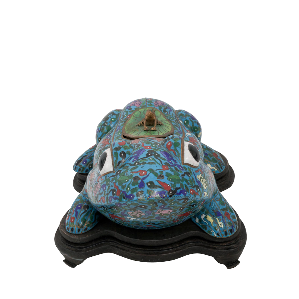 Decorative frog sculpture on a stand with a white background