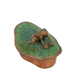Bronze frog on a green lily pad with a white background