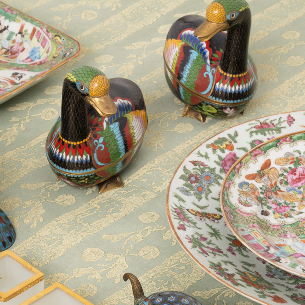 Cloisonne Geese with colorful designs on patterned fabric