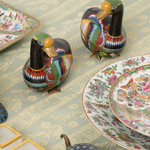 Cloisonne Geese with colorful designs on patterned fabric