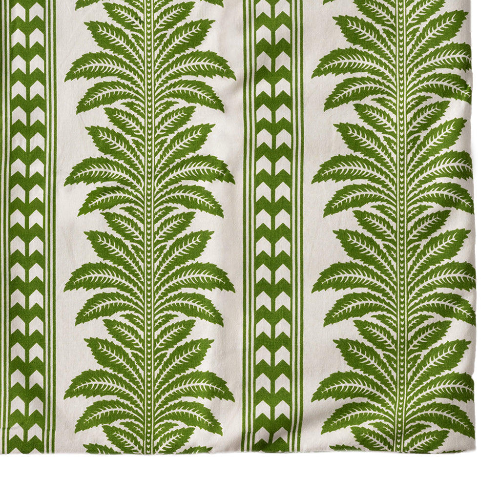 green and white tablecloth with palm tree pattern on a white background