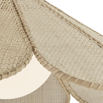 Close-up detail of a woven natural-fiber product, likely a rattan chair or bench, showing the textured beige weave and stitched edges against a white background.