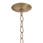 A close-up of a ceiling light fixture's round brushed brass canopy and hanging chain against a plain white background.