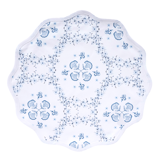 Decorative placemat with blue floral patterns on a white background