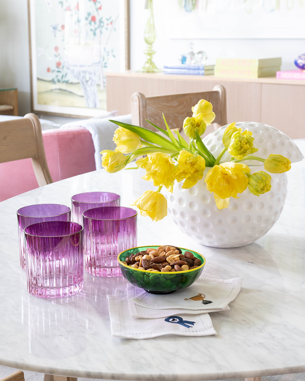 dining table with cocktail classes, nut bowl, and ice bucket