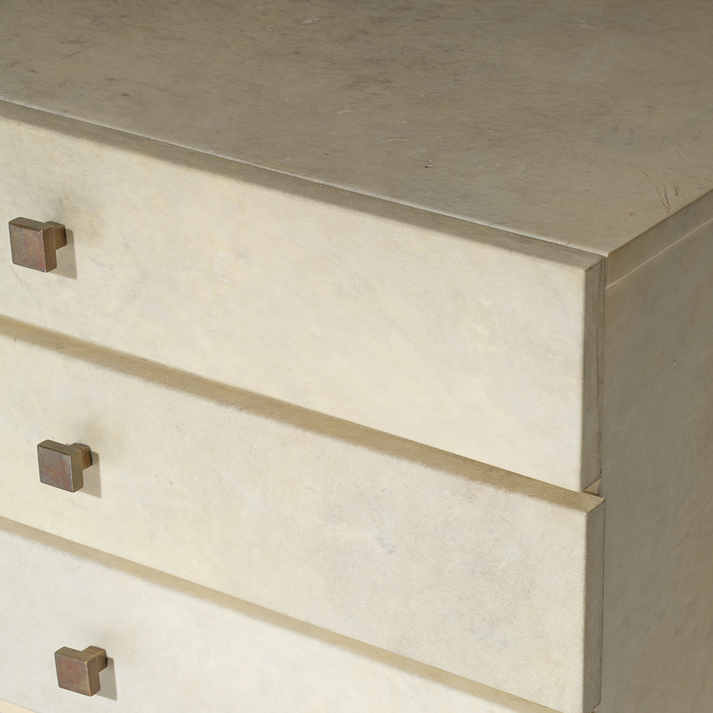 Close-up of a chest with bronze knobs.