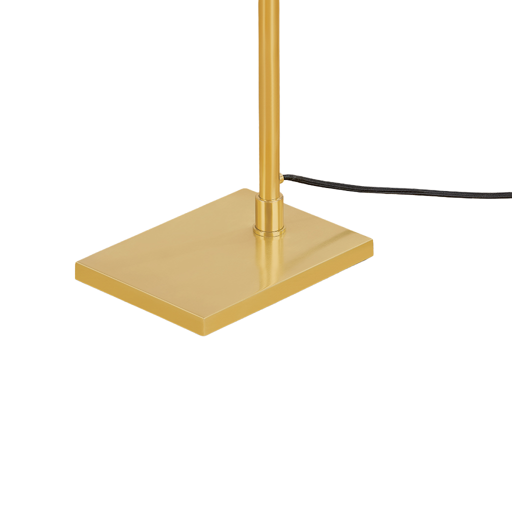 Close-up of a modern lamp base and pole in a brushed gold finish, with a black power cord extending to the right, on a solid white background.