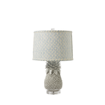 Table lamp with pineapple base and patterned shade on a white background