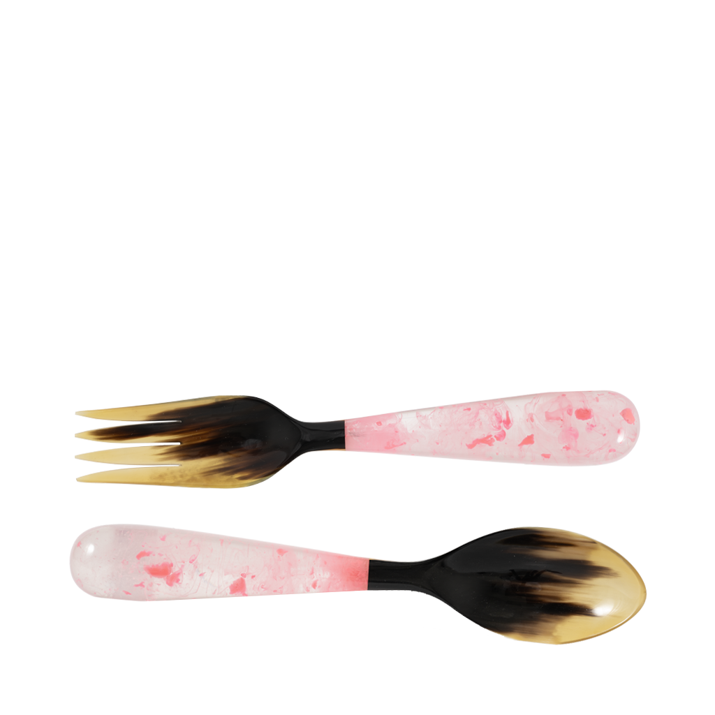 Set of spoon and fork with pink and clear handles on a white background