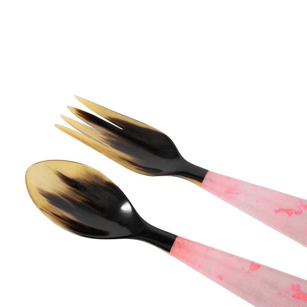 Two black and pink utensils on a white background